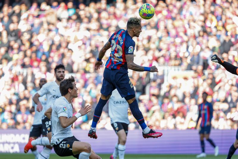 Barcelona's Raphinha scores his side's opening goal during Spanish La Liga soccer match between Barcelona and Valencia at the Camp Nou stadium in Barcelona, Spain, Sunday, March 5, 2023.  (AP Photo / Joan Monfort)