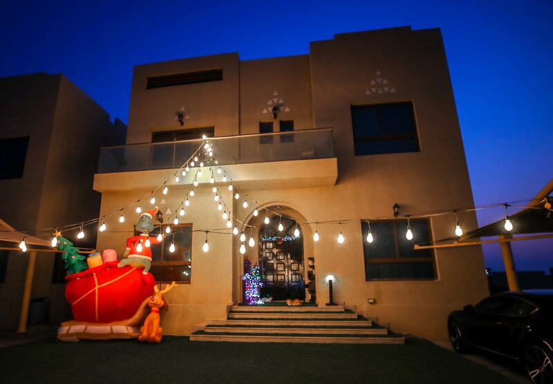 An inflatable Grinch at the entrance of the residence