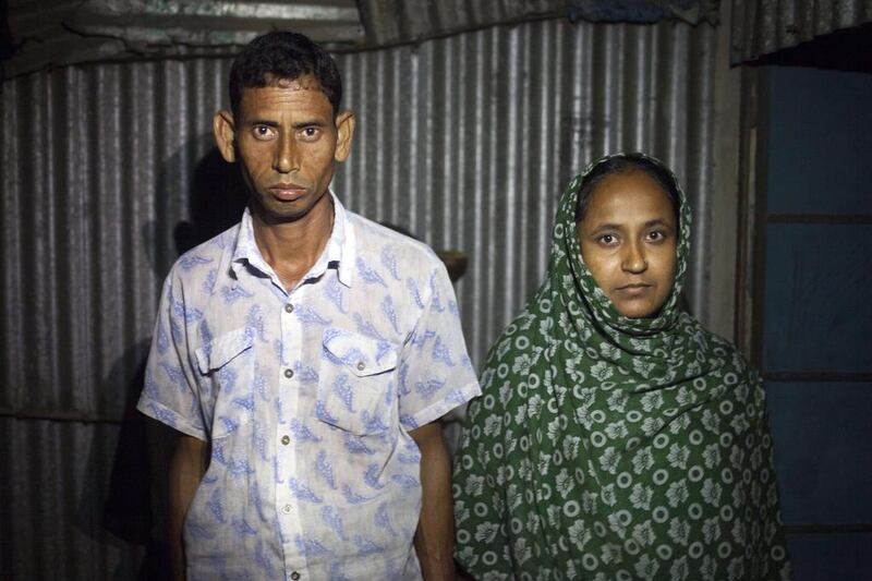 Rawshan Ara, 28 (R) and her husband at their home in the village of Kalai some 300 kms north-west of Dhaka. Suvra Kanti Das / AFP