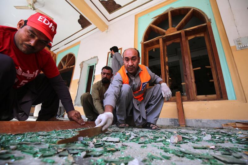 Rescue workers inspect the scene of an explosion at an Islamic seminary in Peshawar, Pakistan.  EPA