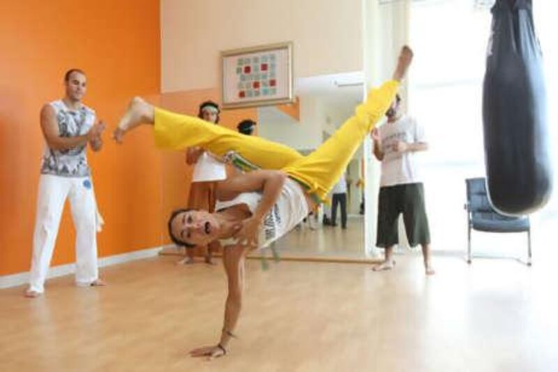 Nina Stone demonstrates a capoeira move to a class in Abu Dhabi.