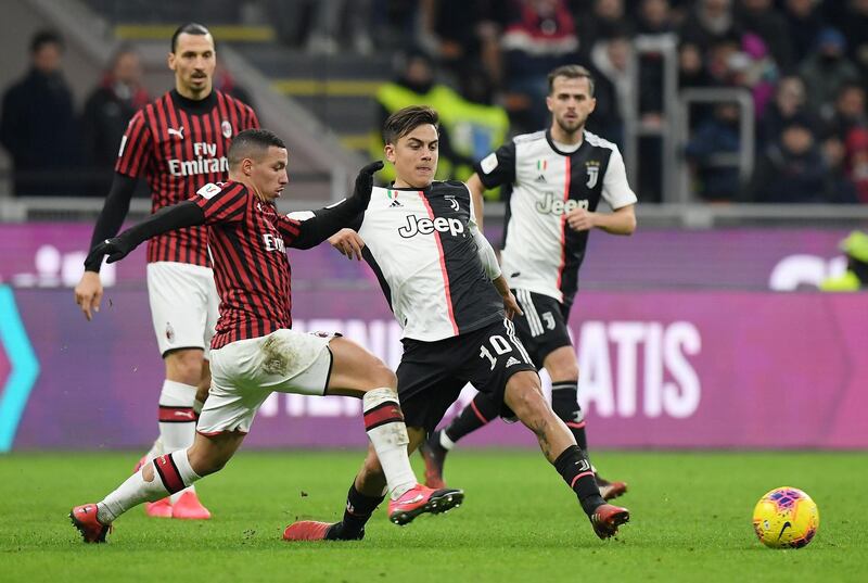 Juventus attacker Paulo Dybala battles for possession with Milan's Ismael Bennacer. Reuters