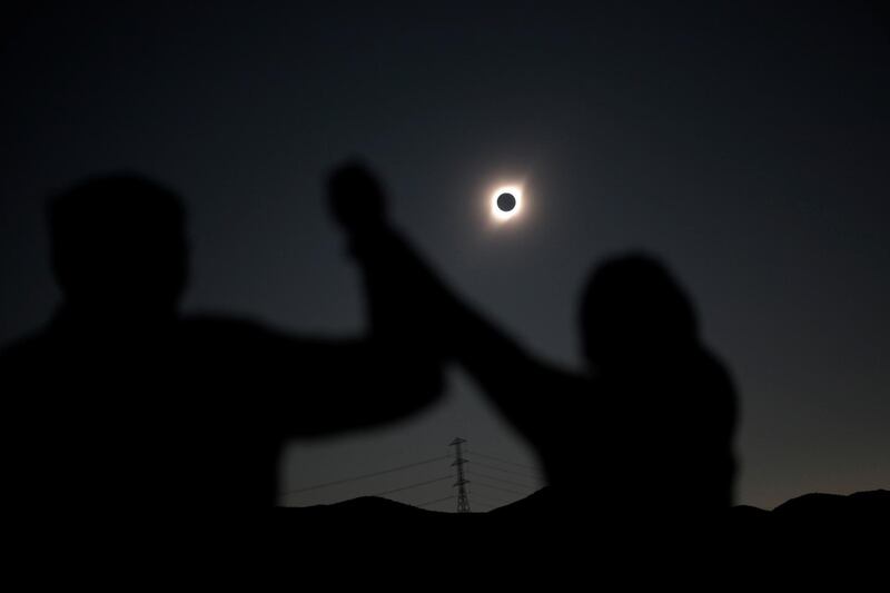 People react while observing a solar eclipse at Incahuasi, Chile. Reuters