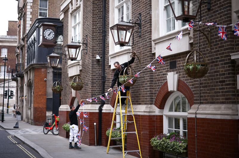 Workers hang bunting outside a hotel in central London. Reuters