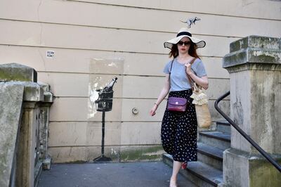 epa06841390 A woman walks by a recent artwork believed to be attributed to Banksy showing a rat on a popped cork from a champagne bottle in the 18th district of Paris, France, 26 June 2018. Several artworks attributed to the anonymous British street artist appeared in the French capital over the last few days.  EPA-EFE/JULIEN DE ROSA