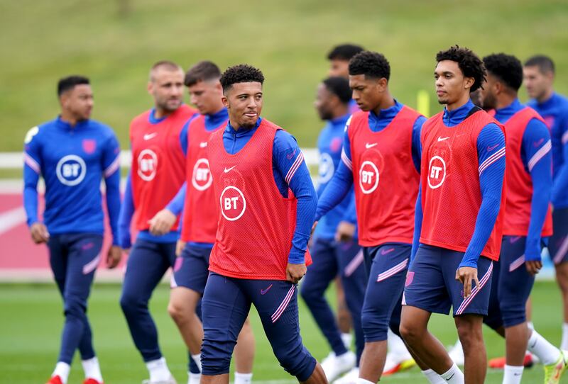 England's Jadon Sancho, centre, and Trent Alexander-Arnold, right, with England teammates. PA