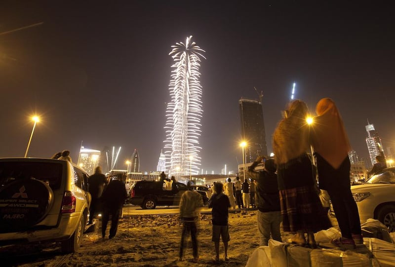 People watch the Burj Khalifa's fireworks display, in 2012, from afar.  Jaime Puebla / The National
