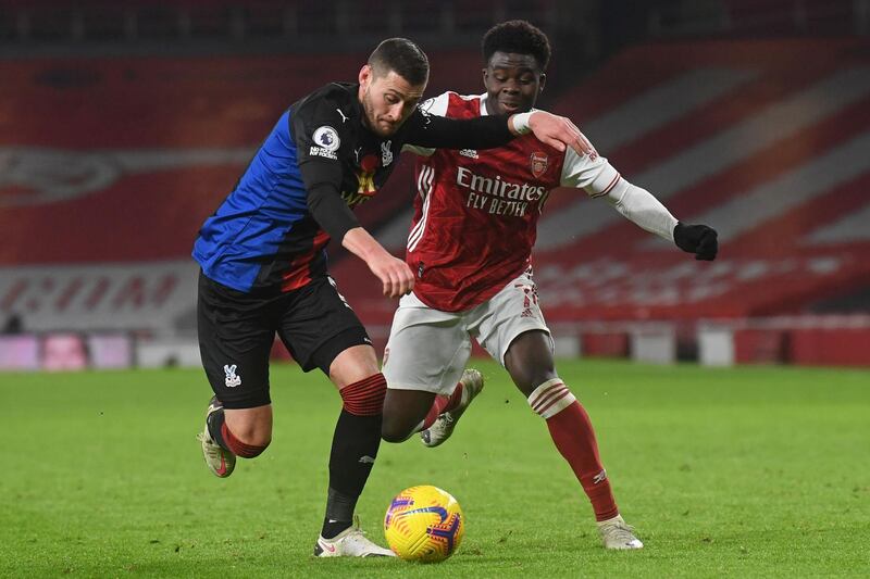 Crystal Palace's English defender Joel Ward (L) vies with Arsenal's English striker Bukayo Saka (R) during the English Premier League football match between Arsenal and Crystal Palace at the Emirates Stadium in London on January 14, 2021.   - RESTRICTED TO EDITORIAL USE. No use with unauthorized audio, video, data, fixture lists, club/league logos or 'live' services. Online in-match use limited to 120 images. An additional 40 images may be used in extra time. No video emulation. Social media in-match use limited to 120 images. An additional 40 images may be used in extra time. No use in betting publications, games or single club/league/player publications.
 / AFP / POOL / NEIL HALL / RESTRICTED TO EDITORIAL USE. No use with unauthorized audio, video, data, fixture lists, club/league logos or 'live' services. Online in-match use limited to 120 images. An additional 40 images may be used in extra time. No video emulation. Social media in-match use limited to 120 images. An additional 40 images may be used in extra time. No use in betting publications, games or single club/league/player publications.

