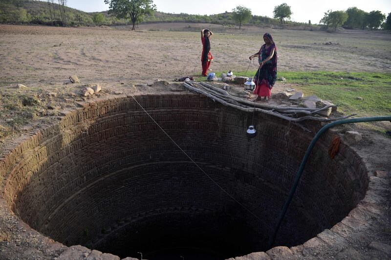 Women collect water from a well in Agrotha village, in India's Madhya Pradesh state. As the monsoon storms bear down on the country, the women hope that water shortages will no longer leave their village high and dry. AFP