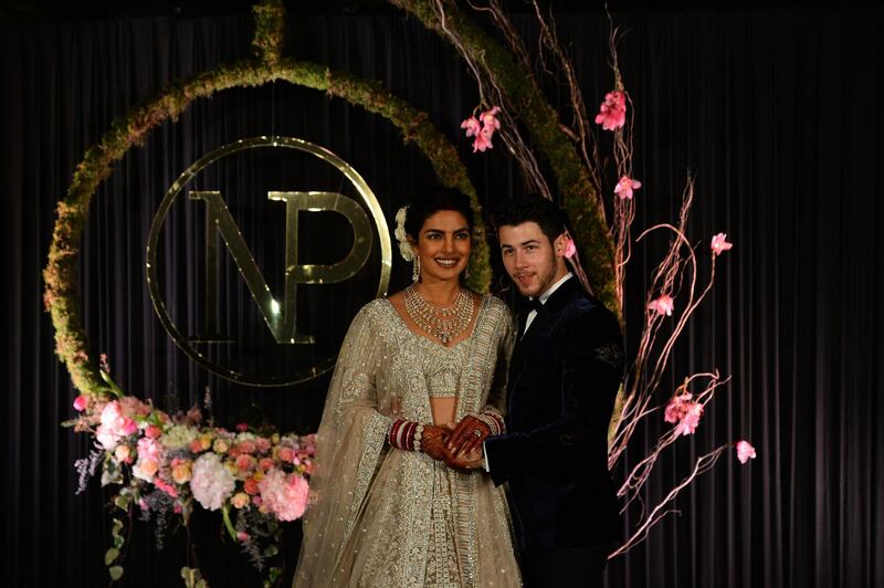 Newlyweds Priyanka Chopra, 36, and Nick Jonas, 26, pose for a photograph during a reception at a hotel in New Delhi on December 4, 2018. Photo: AFP