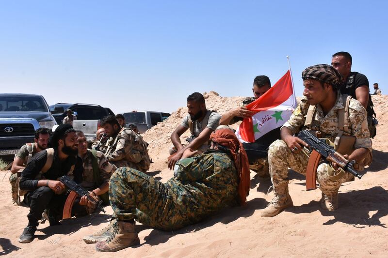 Syrian pro-government forces hold a position near the village of al-Maleha, in the northern countryside of Deir Ezzor, on September 9, 2017, during the ongoing battle against Islamic State (IS) group jihadists.
Syrian troops broke the Islamic State group's siege of the eastern Deir Ezzor military airport, dealing a new blow to the jihadists who were facing a new offensive from US-backed fighters elsewhere in the province. / AFP PHOTO