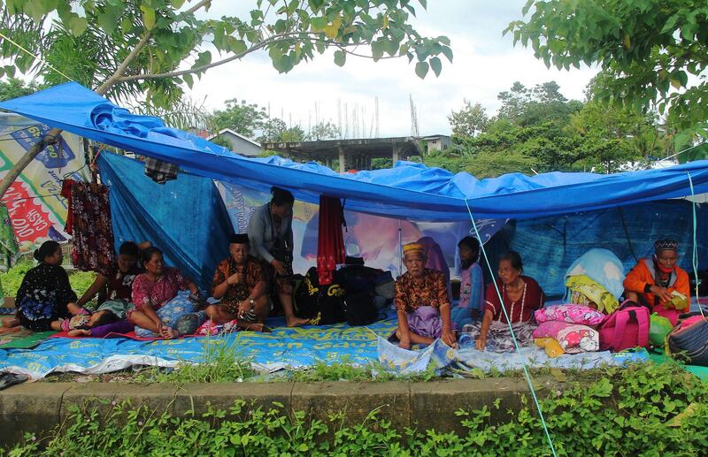 Locals who fled to higher ground are seen at a temporary shelter following an earthquake in Mamuju, West Sulawesi province, Indonesia, January 16, 2021 in this photo taken by Antara Foto. Antara Foto/Akbar Tado/ via Reuters