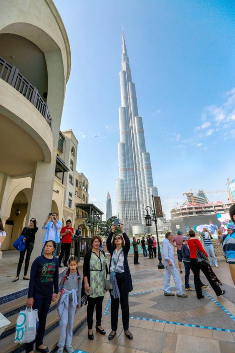 Visitors take pictures of the fire damage sustained to The Address Hotel in Dubai.