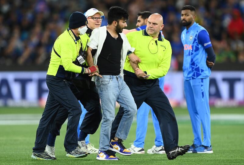 A pitch invader runs onto the field at Melbourne Cricket Ground on Sunday. Getty