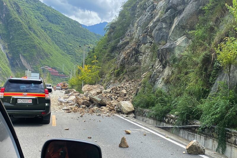 The quake triggered landslides on the road heading into Luding county. AP