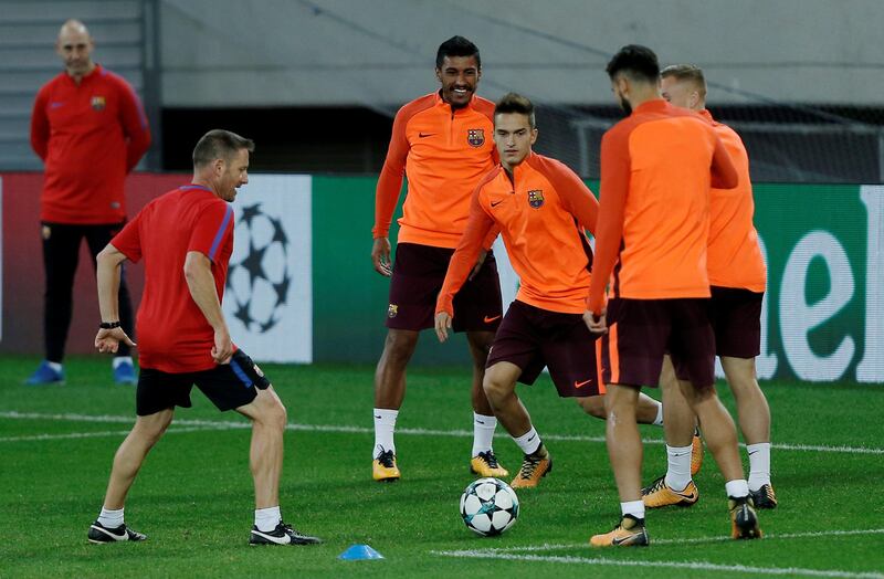 Denis Suarez, centre, takes part in a training session as Paulinho looks on. Costas Baltas / Reuters