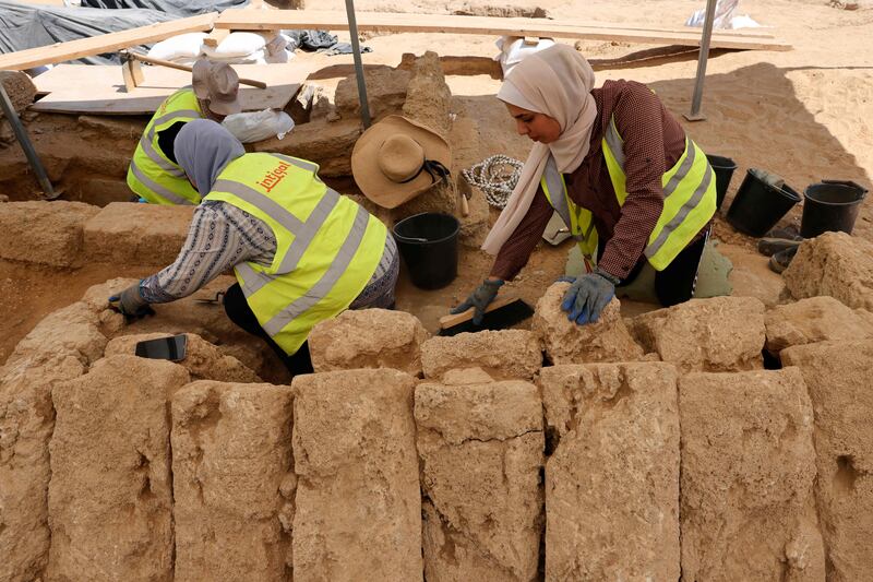 Workers brush blocks of stone during excavations at the site this week. AFP