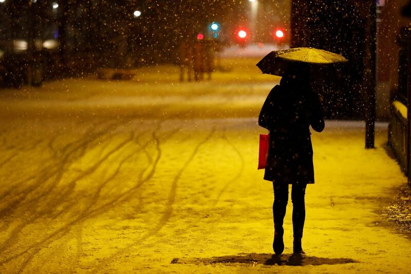 A woman walks after a curfew in Strasbourg, eastern France. AP Photo