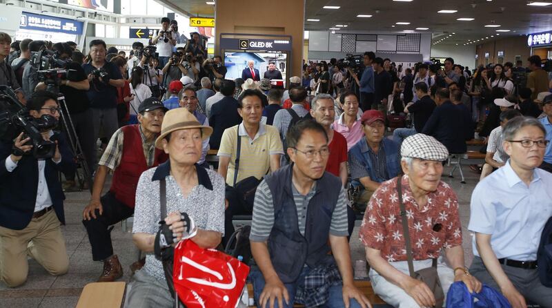 South Koreans watch a television broadcasting news of the event. EPA