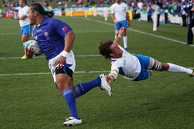 Samoa's Alesana Tuilagi, left, evades the tackle of Namibia's Jacques Burger during their Rugby World Cup game in Rotorua, New Zealand, Wednesday, Sept. 14, 2011.(AP Photo/Dita Alangkara)