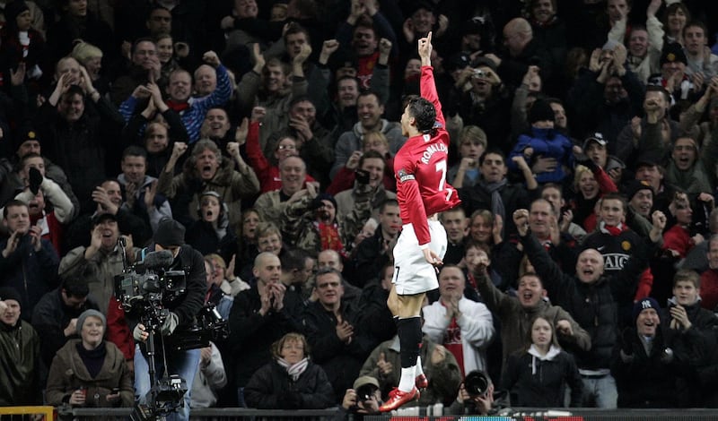 Manchester United's Portugese midfielder Cristiano Ronaldo of Portugal celebrates scoring against Bolton Wanderers during their English Premier League football match at Old Trafford in manchester, north west England, March 19, 2008. AFP PHOTO/PAUL ELLIS
 - (Photo by PAUL ELLIS / AFP)