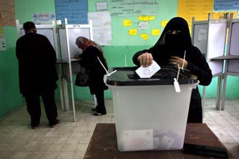 An Egyptian woman casts her vote at a polling station in the second round of a referendum on a disputed constitution drafted by Islamist supporters of president Mohammed Morsi.