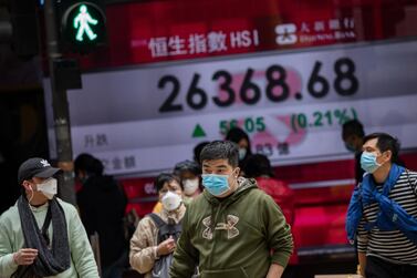 Pedestrians walk past an electronic billboard showing the Hang Seng Index figures in Hong Kong, China on February 3. EPA