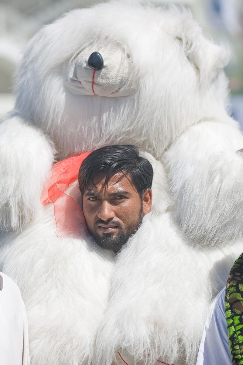 United Arab Emirates -Dubai- April 22, 2009:

SPORTS: A fan waits in line with a giant stuffed bear to see Pakistan takes on Australia during the Chapal Cup at the Dubai Sports City stadium in Dubai on Wednesday, April 22, 2009. Amy Leang/The National
 *** Local Caption ***  amy_042209_cricket_08.jpg