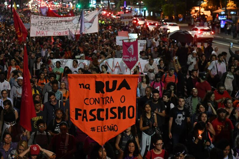 Demonstrators take part in a protest against Brazilian right-wing presidential candidate Jair Bolsonaro in Sao Paulo, Brazil, on October 10 2018. The populist ultra-conservative won 46 percent of the vote in the first round, despite detractors highlighting his contentious past comments demeaning women and gays, and speaking in favor of torture and Brazil's 1964-1985 military dictatorship. Brazil will hold the run-off presidential election next October 28. / AFP / NELSON ALMEIDA
