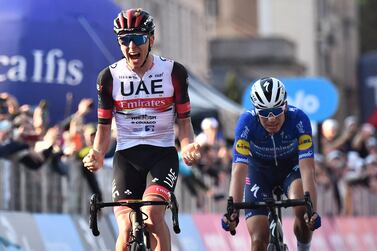Team UAE Emirates' Tadej Pogacar of Slovenia (L) celebrates as he crosses the finish line of the 115th edition of the Giro di Lombardia (Tour of Lombardy), a 239 km (148,5 miles) cycling race from Como to Bergame on October 9, 2021.  (Photo by Marco BERTORELLO  /  AFP)