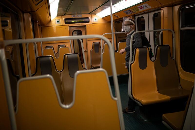 A passenger wears a face shield and mask on public transport in Brussels. (AP