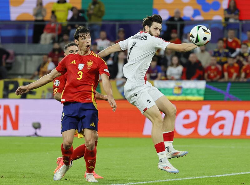 Spain's Robin Le Normand, left, reacts after scoring an own goal off his chest to give Georgia the lead. EPA
