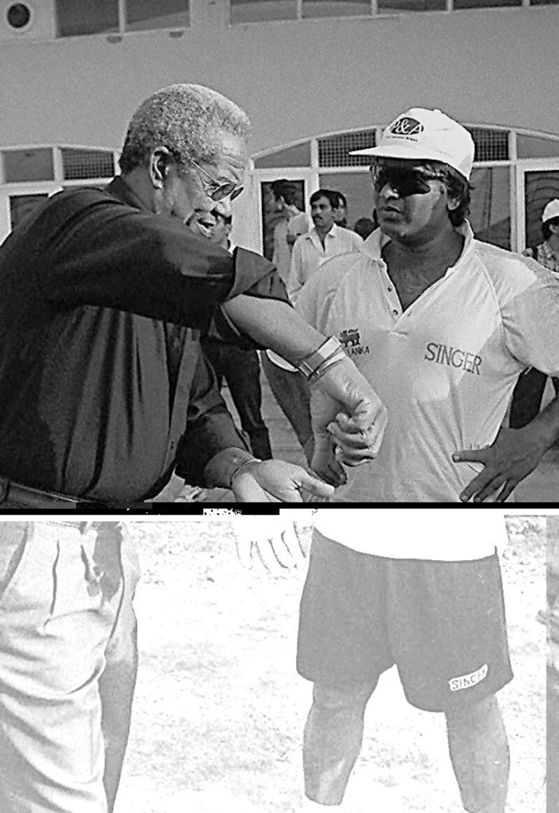 Former West Indian captain Sir Gary Sobers (left) gives a few tips Arjuna Ranatunga of Sri Lanka 23 May on the eve of the first final to be played against Pakistan at the Mohali cricket stadium in Chandigarh. (B/W ONLY)