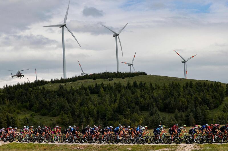 The peloton rides past windturbines at Forca Caruso mountain pass near Collarmele. AFP