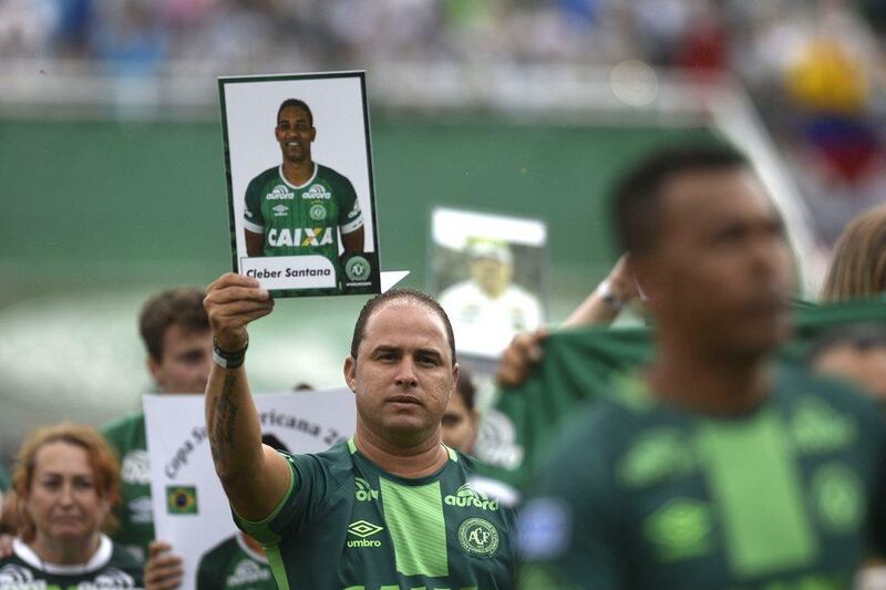 Relatives of members of the Chapecoense football club team killed in an air crash in Colombia pay tribute to their loved ones, at the stadium in Chapeco, Santa Catarina, southern Brazil, on December 3, 2016. Douglas Magno / AFP