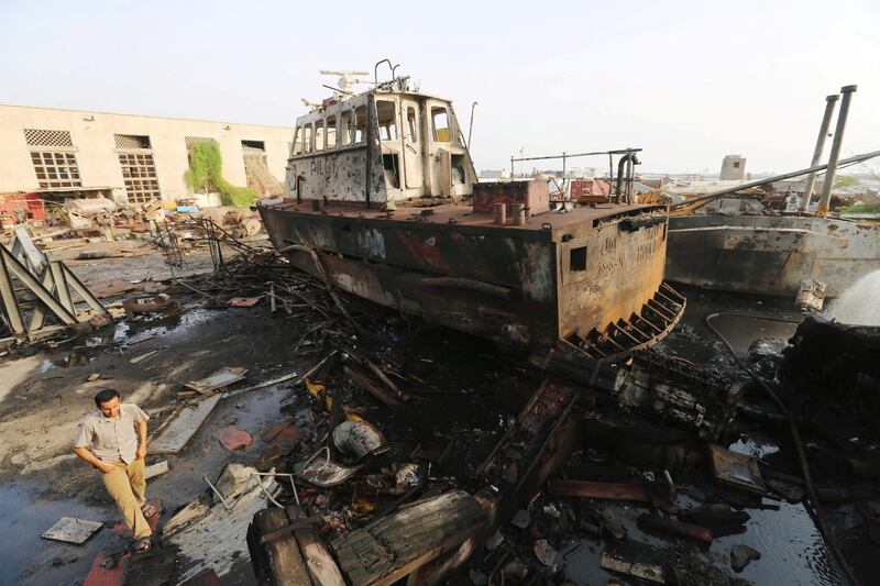 A worker walks past a tug damaged by an air strike on the maintenance hub at the Hodeida port, Yemen May 27, 2018. REUTERS/Abduljabbar Zeyad