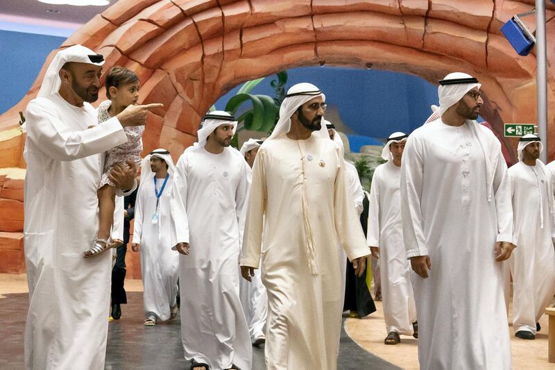 YAS ISLAND, ABU DHABI, UNITED ARAB EMIRATES - July 23, 2018: HH Sheikh Mohamed bin Zayed Al Nahyan, Crown Prince of Abu Dhabi and Deputy Supreme Commander of the UAE Armed Forces  (L), HH Sheikha Salama bint Diab bin Mohamed bin Zayed Al Nahyan (2nd L), HH Sheikh Mohamed bin Rashid Al Maktoum, Vice-President, Prime Minister of the UAE, Ruler of Dubai and Minister of Defence (C) and HE Mohamed Khalifa Al Mubarak, Chairman of the Department of Culture and Tourism and Abu Dhabi Executive Council Member (R) attend the opening of Warner Bros. World Abu Dhabi. Seen with HH Sheikh Hamdan bin Mohamed Al Maktoum, Crown Prince of Dubai (back). 

( Hamad Al Kaabi / Crown Prince Court - Abu Dhabi )
---