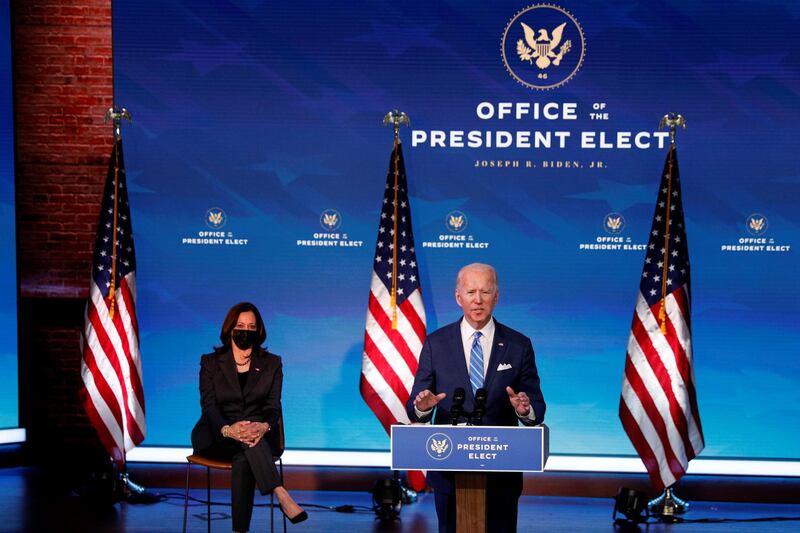 US President-elect Joe Biden delivers remarks as Vice President-elect Kamala Harris looks on during a televised speech at The Queen Theatre in Wilmington, Delaware. Reuters