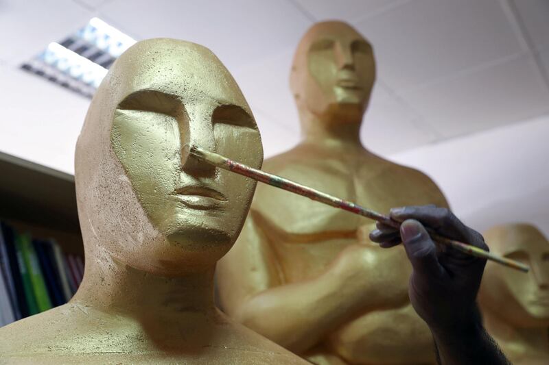 Dubai, United Arab Emirates - January 10th, 2018: Photo project. Sculptor Mark Ranasinghe applies the final touches to his giant oscar sculptures made out of polystyrene. Wednesday, January 10th, 2018 at Al Quoz, Dubai. Chris Whiteoak / The National