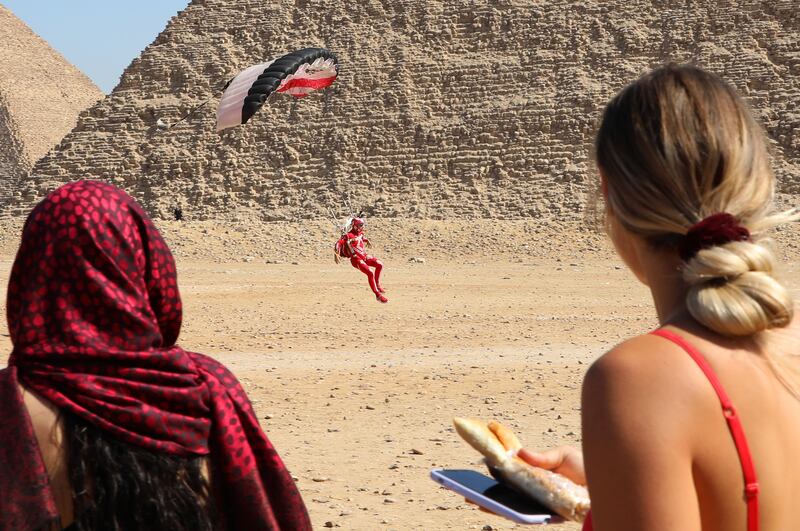 A skydiver lands in front of the Great Pyramids. The festival aims to promote Egypt’s ailing tourism industry.  EPA
