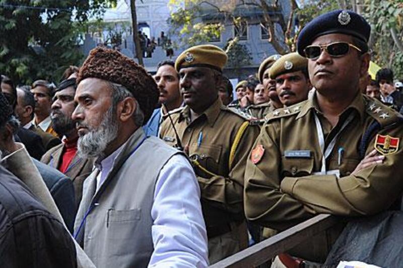 Protesters and policemen listen to an announcement cancelling a video conference with Salman Rushdie at the Jaipur Literature Festival yesterday. The cancellation followed warnings that Muslim groups were threatening attacks if the call went ahead.