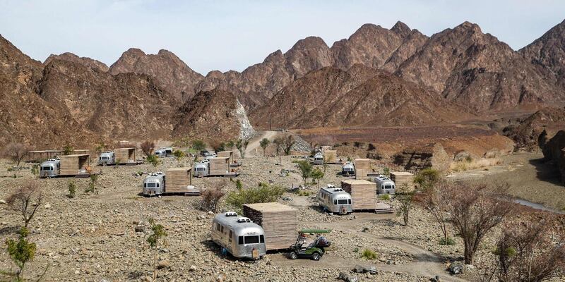 This picture taken on February 15, 2019 shows a view of a tourist caravan camped at a mountain campsite in the Dubai emirate's exclave of Hatta, near the Omani border. Some 100 kilometres from Dubai's skyscrapers, "glamping" in luxurious trailer-style set-ups and mountainside lodgings is the next big thing in the desert country. Betting on tourism at a time of low oil prices, Dubai has pushed a blend of camping and luxury hotels -- "glamping", short for "glamourous camping". The city welcomed a record 15.92 million visitors in 2018, many of whom were drawn to its mega malls, luxurious hotels and pristine beaches. / AFP / KARIM SAHIB
