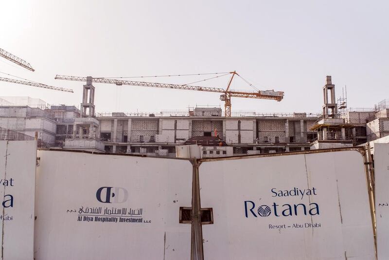 Cranes stand at a construction site for the Saadiyat Rotana Hotel on Saadiyat Island in Abu Dhabi in May. Alex Atack / Bloomberg