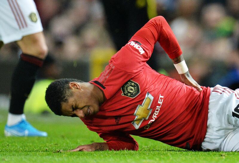 Marcus Rashford of Manchester United holds his back in pain. EPA