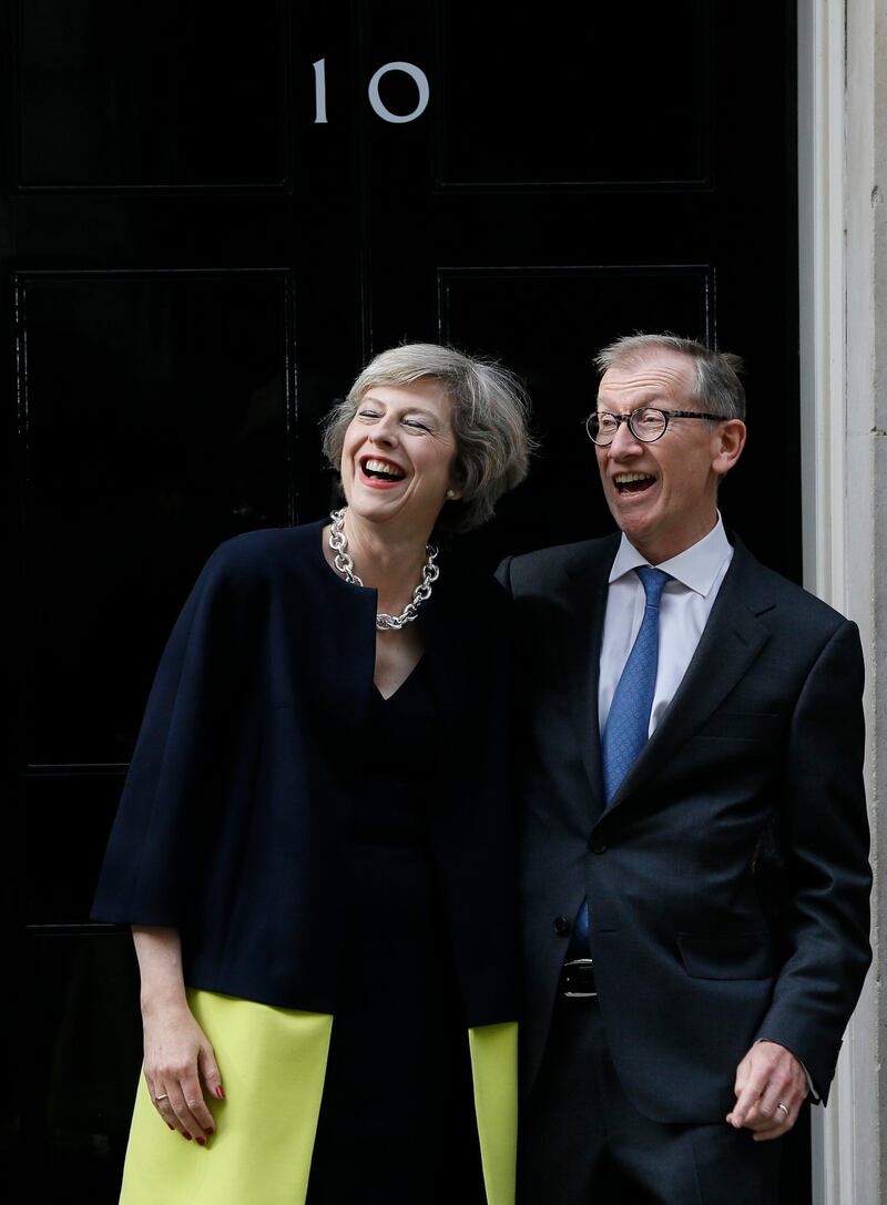 British Prime Minister Theresa May and her husband Philip May stand on the steps of 10 Downing Street in London on July 13, 2016. AP Photo