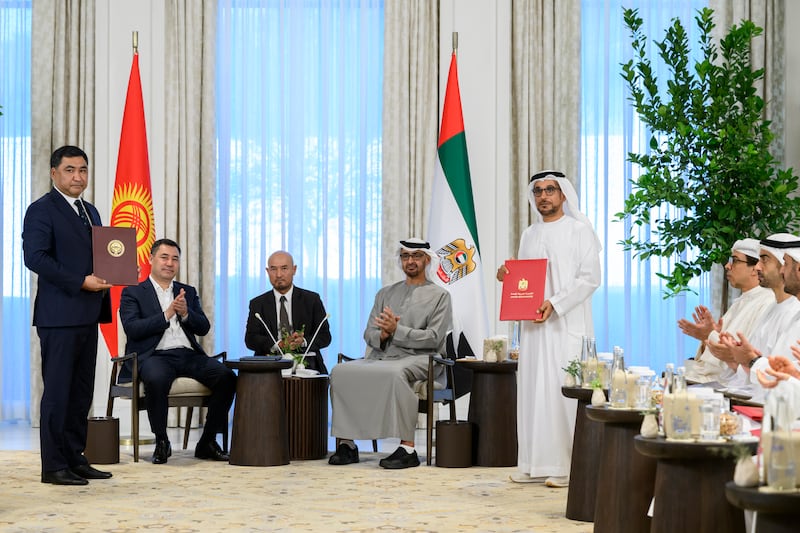 Mohammed Al Suwaidi, director general of the Abu Dhabi Fund for Development, and Daniyar Amangeldiev, Kyrgyzstan's Minister of Economy, exchange agreements.