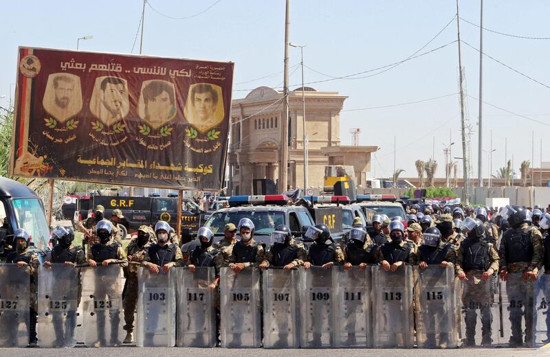 Iraqi security forces are seen during an anti-government protest in front of the Governorate building in Basra, Iraq. Reuters