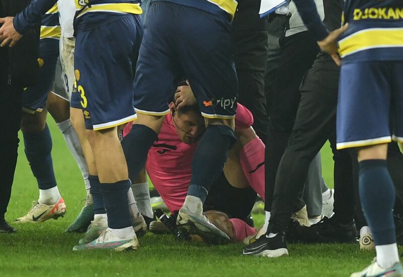 Referee Halil Umut Meler lies on the ground after being attacked by Ankaragucu president Faruk Koca and Ankaragucu supporters at the end the Turkish Super Lig match against Rizespor. Reuters