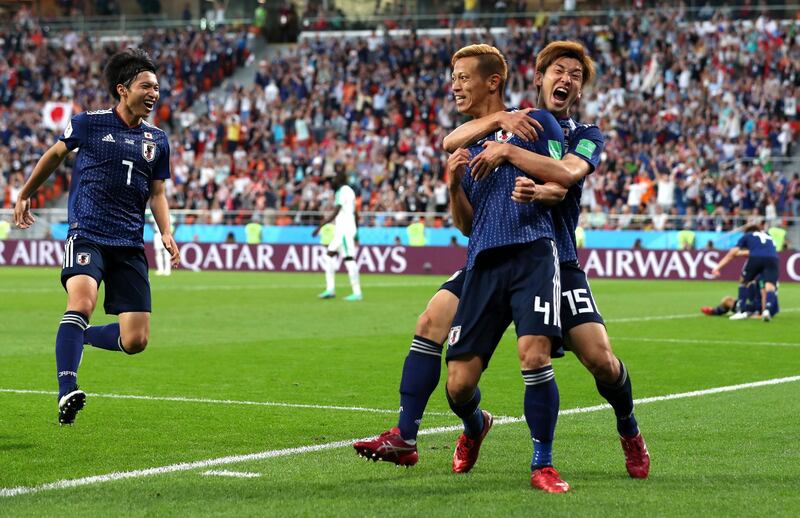 YEKATERINBURG, RUSSIA - JUNE 24:  Keisuke Honda of Japan celebrates with teammate Yuya Osako after scoring his team's second goal during the 2018 FIFA World Cup Russia group H match between Japan and Senegal at Ekaterinburg Arena on June 24, 2018 in Yekaterinburg, Russia.  (Photo by Clive Rose/Getty Images)