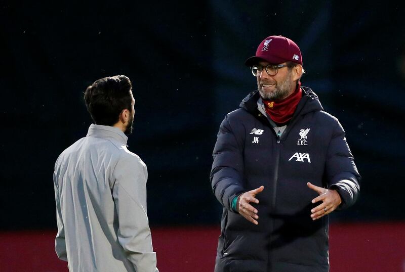 Liverpool manager Juergen Klopp talks to Adam Lallana . Reuters